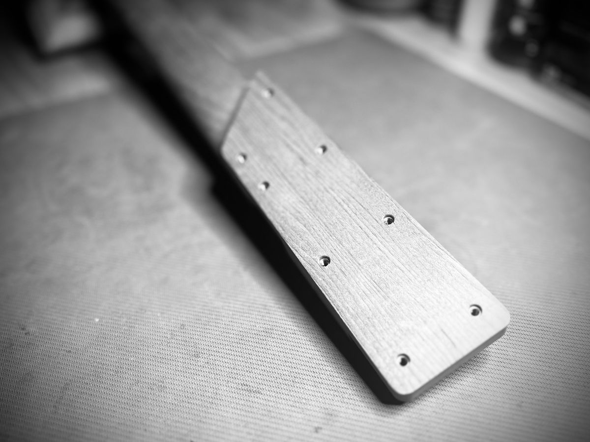 Underside of the neck heel with screw holes