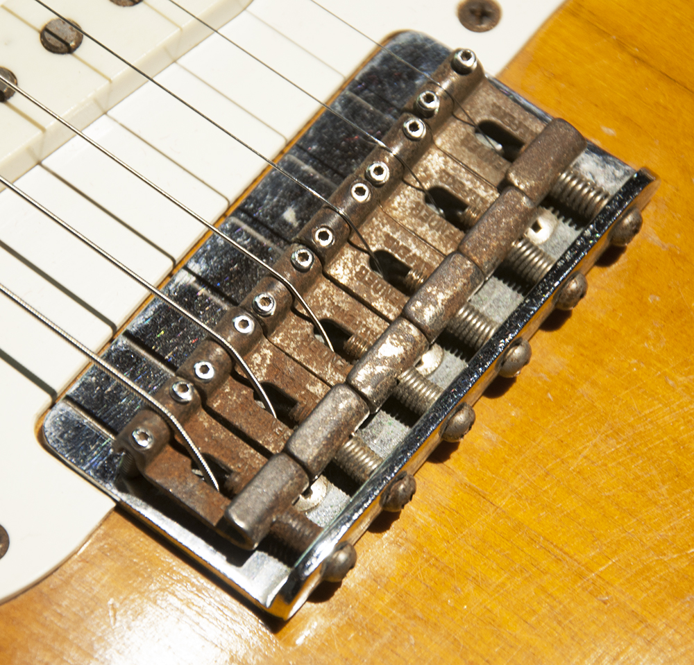 1958 Fender Stratocaster bridge before restoration, bent-steel saddles on a stamped plate