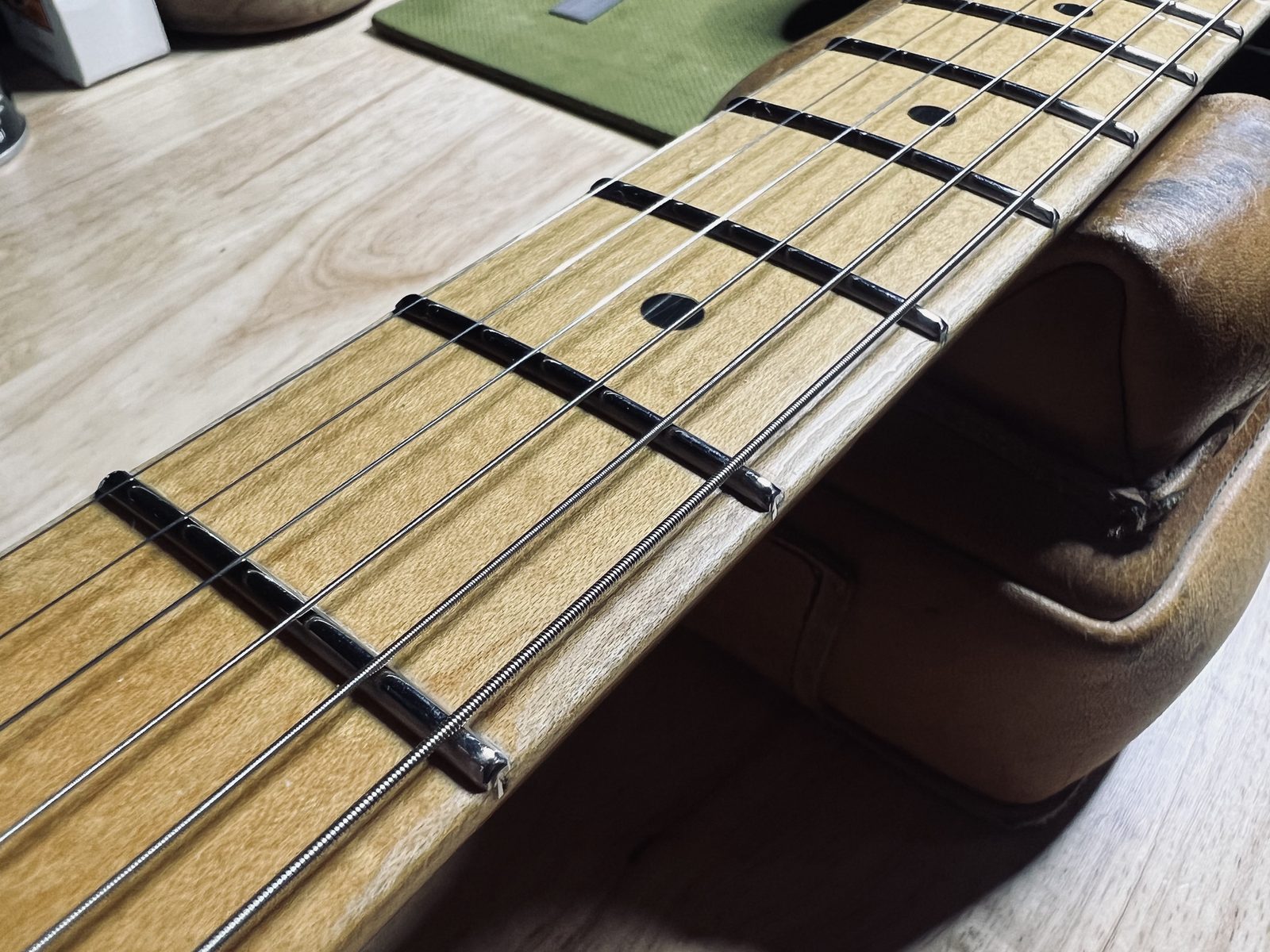 Faceted Artifact snakehead stainless fret ends down the bass edge of a 1991 Fender Stratocaster maple fretboard